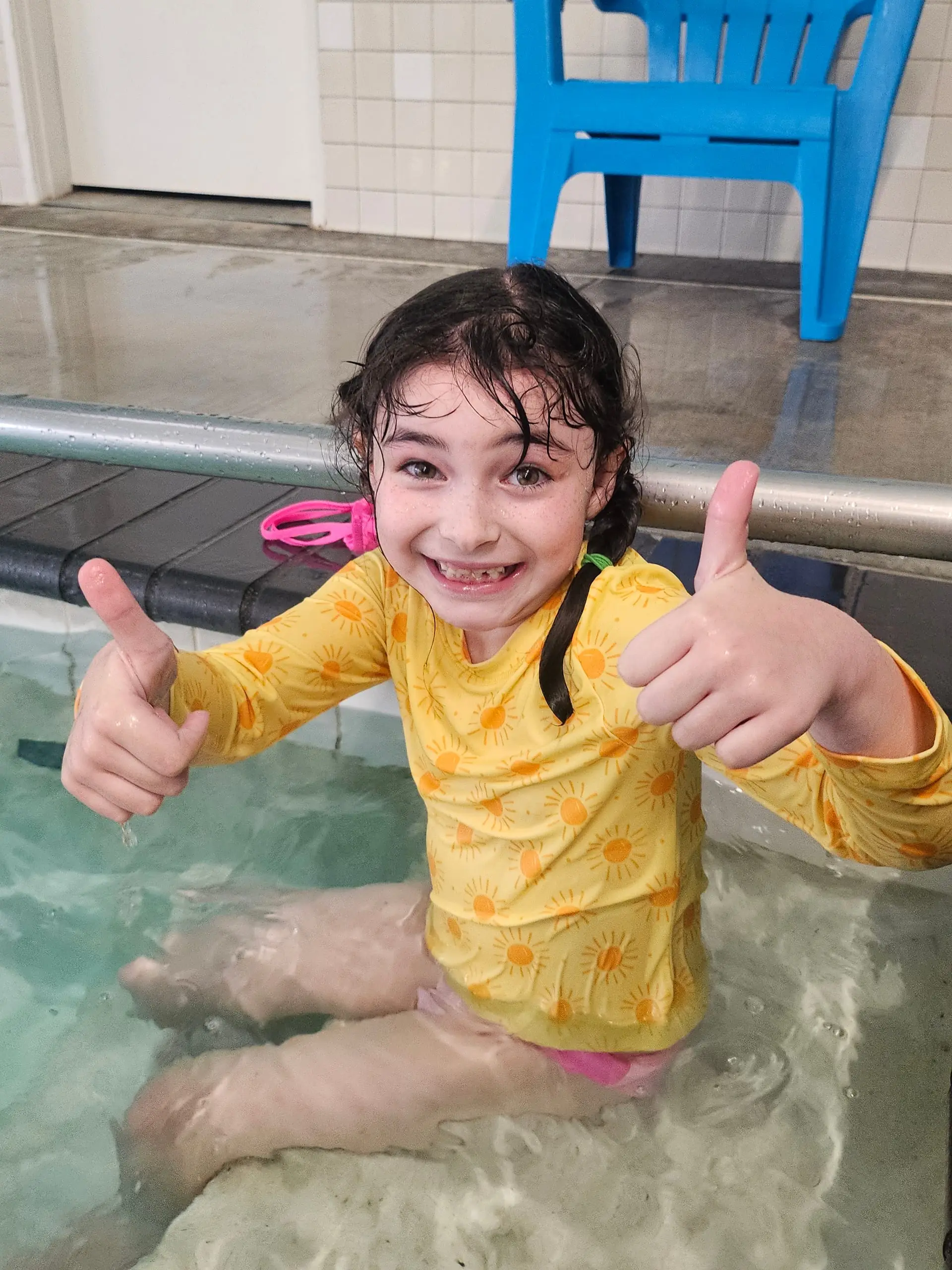 A young swimmer giving two thumbs up in the Arcata pool