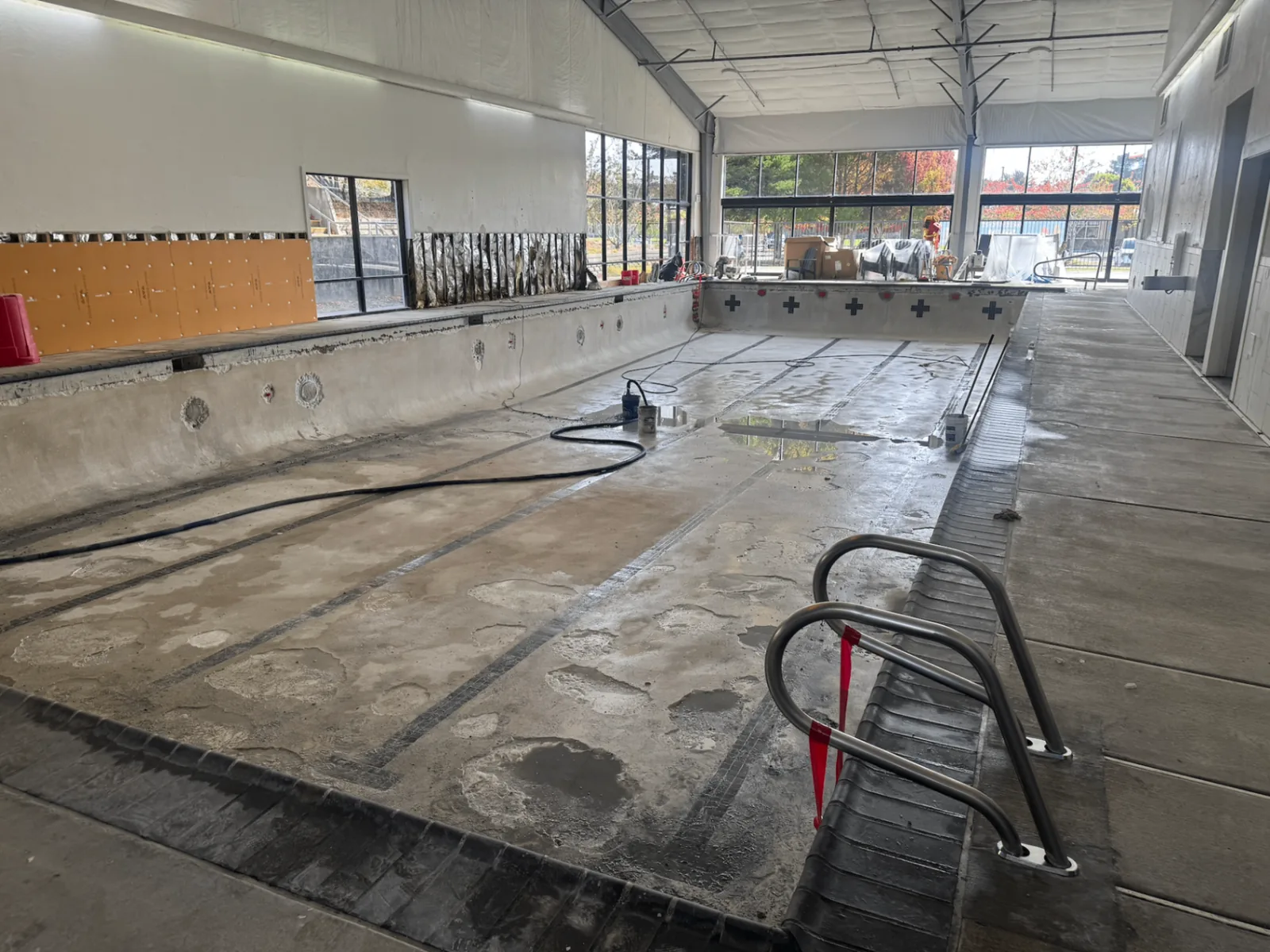 Wide view of the drained Arcata pool while resurfacing and wall work are underway