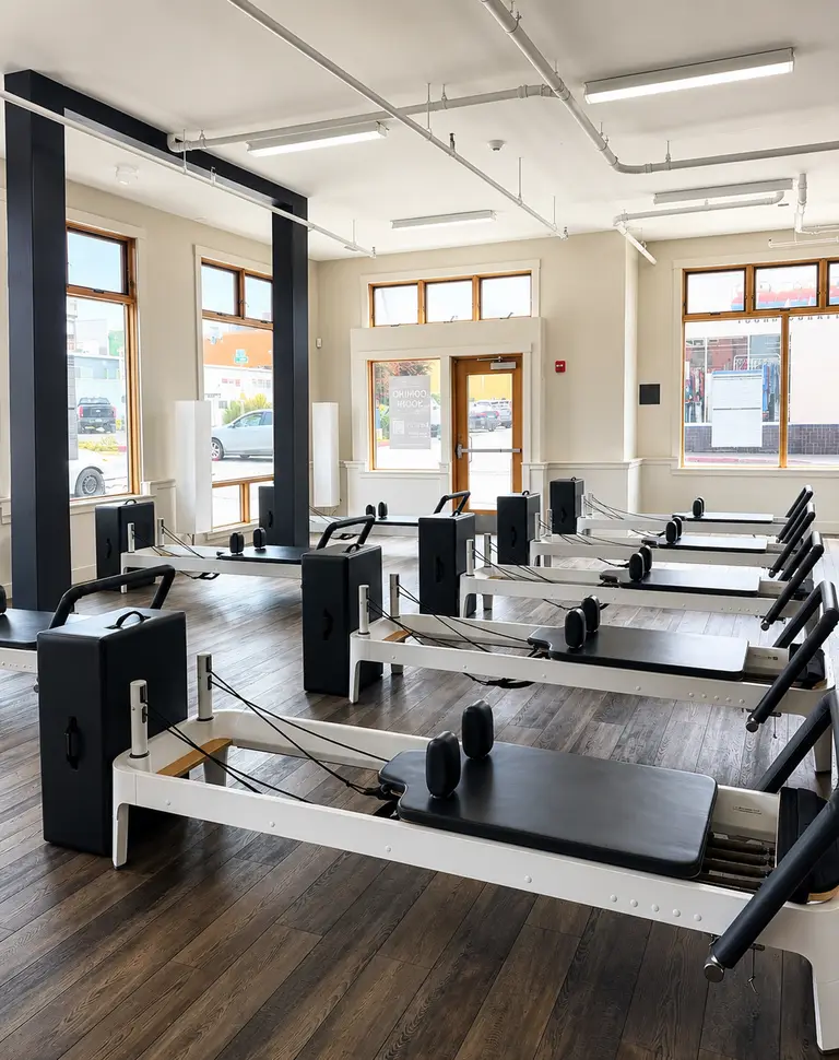 Instructor coaching a client through Reformer work in the HealthSPORT Align studio