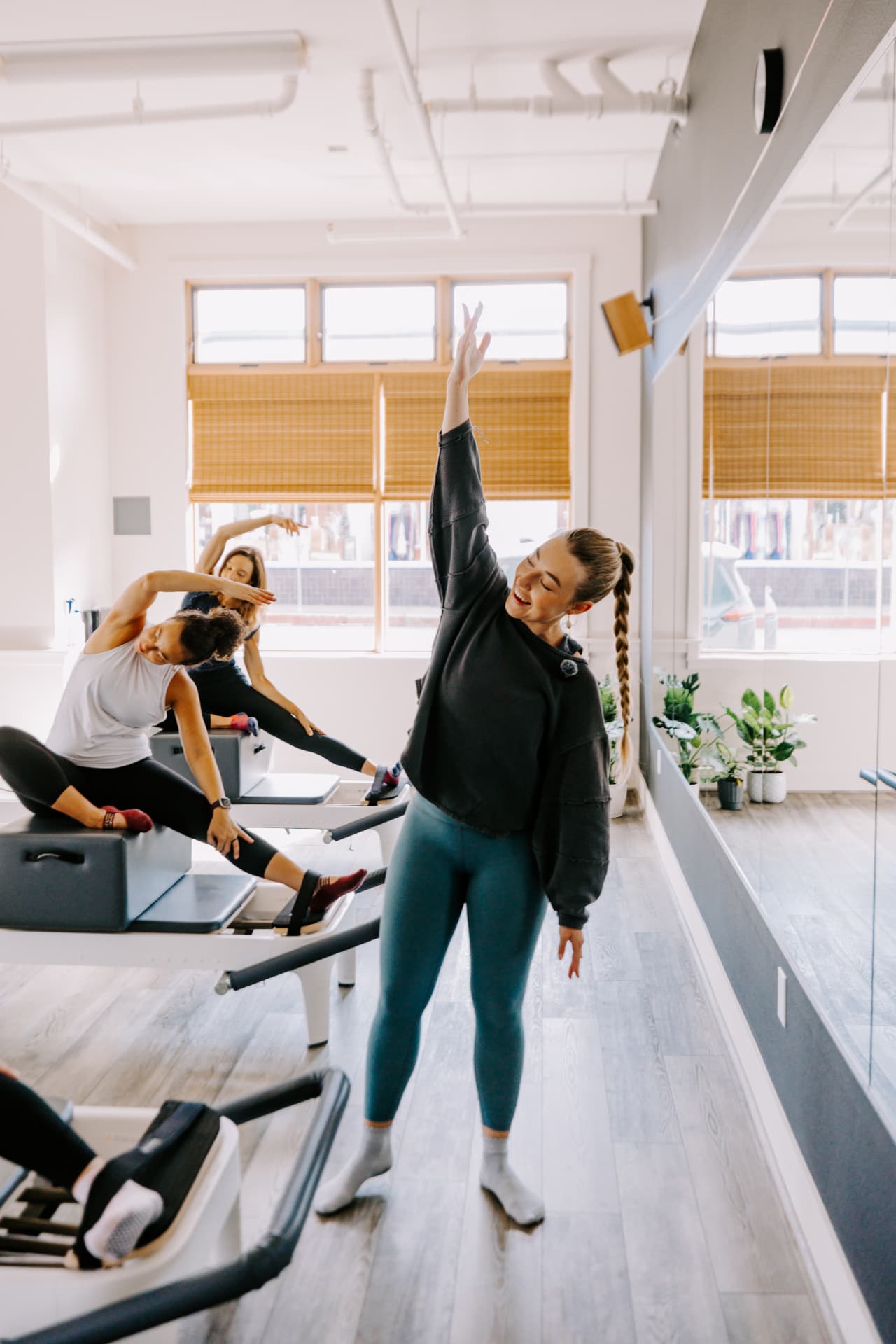 HS Align instructor leading a Reformer class in the new Arcata studio, members stretching on reformers behind her