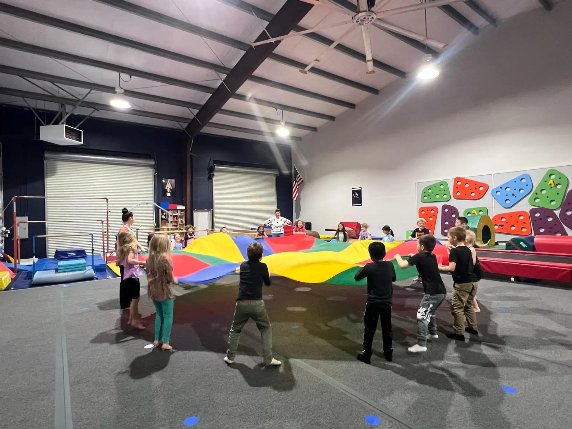 Children playing with a parachute during a HealthSPORT gymnastics field trip