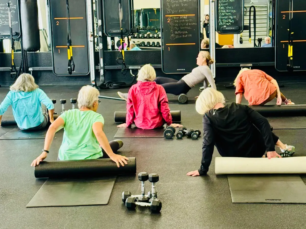 Members working through guided foam-roller recovery in the McKinleyville club